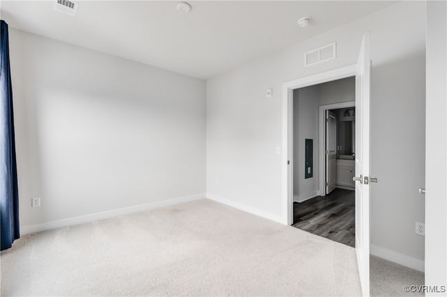 Empty room with carpet flooring and a smoke detector | Image 22