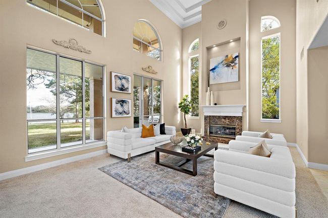 The open floor plan seamlessly connects the plush living area with the sophisticated dining space, creating an ideal setting for upscale entertaining and comfortable living. | Image 10