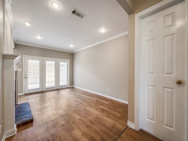 Living room features fire place and luxury plank vinyl floors. | Image 4