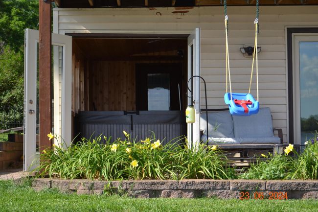 Perennial garden beds and hot tub access perfect for unwinding after a day on the lake | Image 49