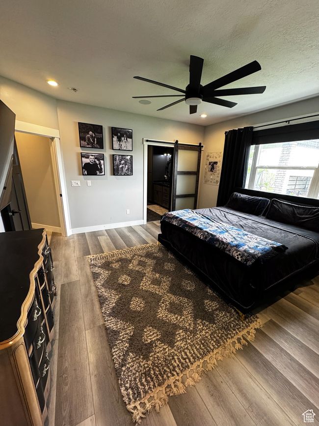 Bedroom with dark wood-type flooring, recessed lighting, baseboards, and ceiling fan | Image 10