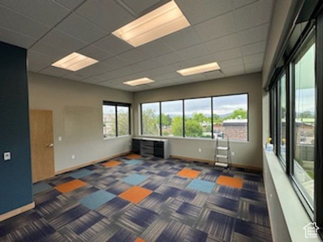 Carpeted empty room featuring baseboards and a paneled ceiling | Image 6