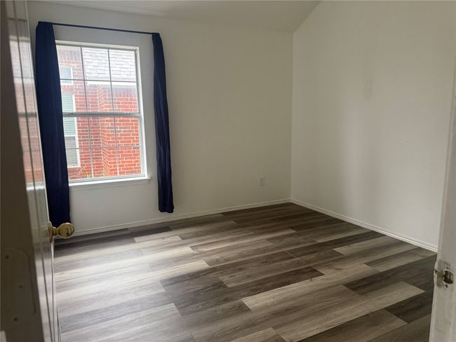Unfurnished room with baseboards, wood finished floors, and a healthy amount of sunlight | Image 17