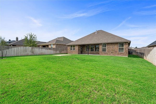 Rear view of property featuring brick siding and roof with shingles | Image 35