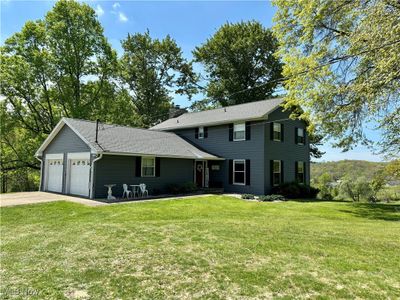 View of front of home featuring a garage and a front yard | Image 1