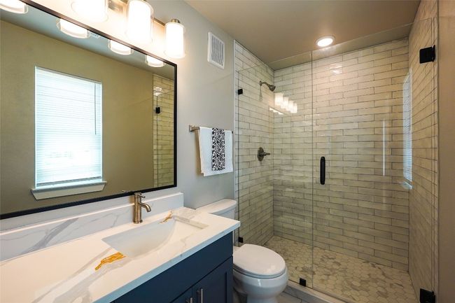 Full bathroom with a stall shower, vanity, and recessed lighting | Image 28