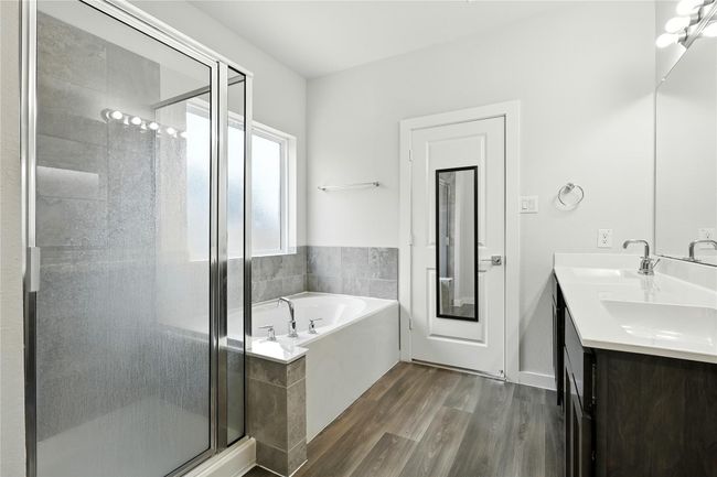 Master bathroom has double sinks, soaking tub, and separate shower. | Image 11