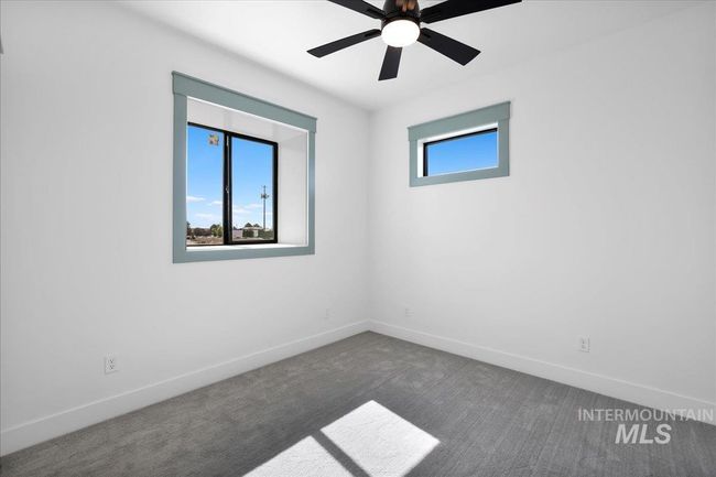 Empty room with carpet flooring and a ceiling fan | Image 33