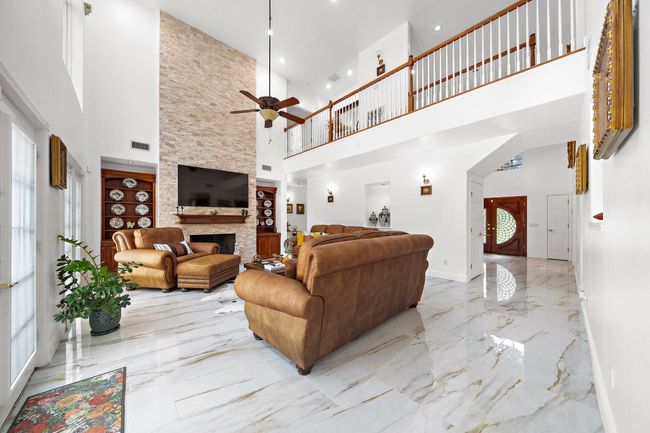 Bright living room with a fireplace and balcony view | Image 7