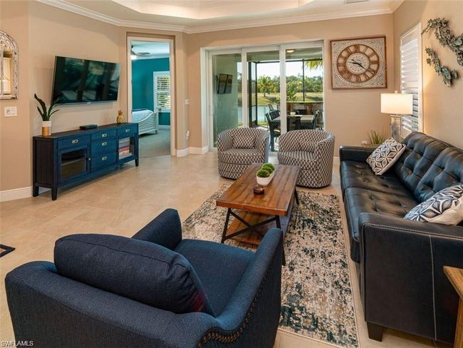 Living room with ornamental molding and a tray ceiling | Image 5
