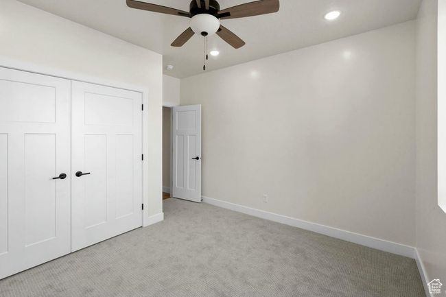 Unfurnished bedroom with recessed lighting, a closet, baseboards, light colored carpet, and ceiling fan | Image 16
