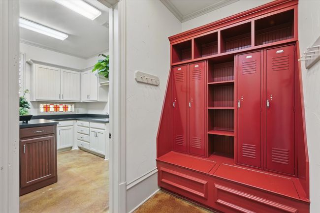 The mud room makes storing backpacks and cleats easy and the oversized laundry room has space for a fridge or freezer, and has a sink, built in ironing board, and a trash compactor. | Image 39