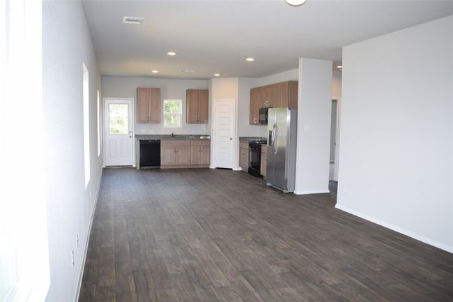 Kitchen featuring black appliances, recessed lighting, and dark wood-type flooring | Image 4
