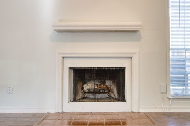 Detailed view of a fireplace and baseboards | Image 8