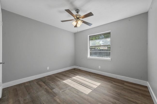 Unfurnished room featuring ceiling fan and dark wood-type flooring | Image 27