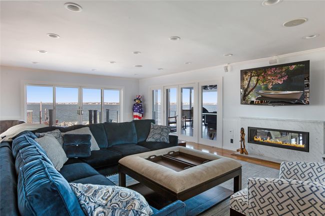 Living area with french doors, recessed lighting, a premium fireplace, ornamental molding, and wood finished floors | Image 8