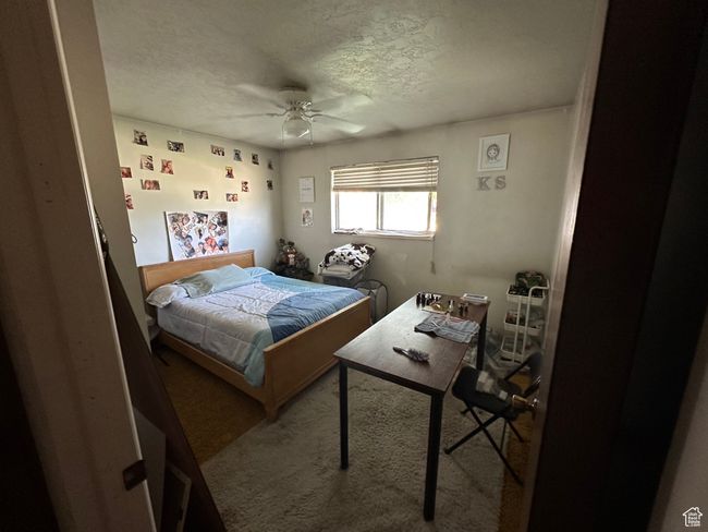Bedroom with carpet, a textured ceiling, and a ceiling fan | Image 13