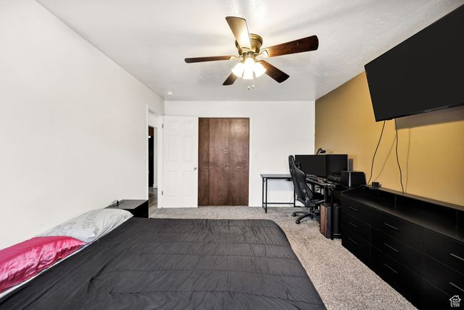 Bedroom featuring carpet flooring, a desk, and a ceiling fan | Image 18