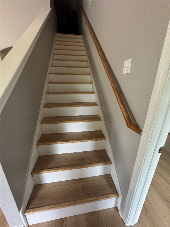 Stairway featuring wood finished floors | Image 15