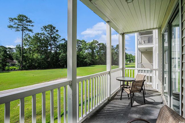 Sunroom / solarium with view of wooded area | Image 22