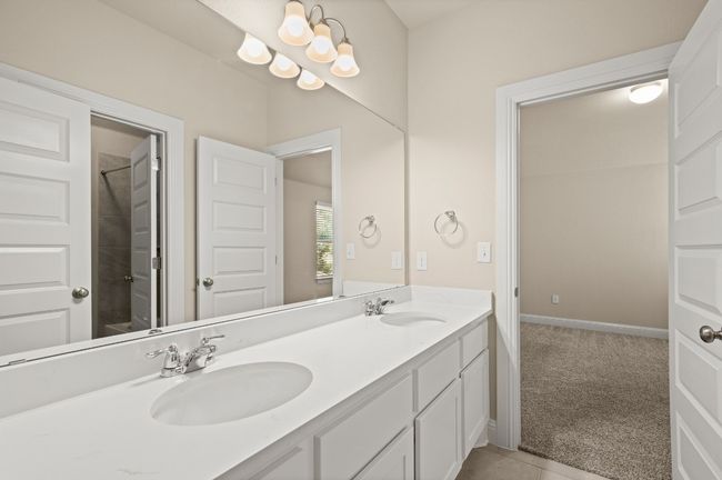 Full bath with double vanity, baseboards, and a sink | Image 23