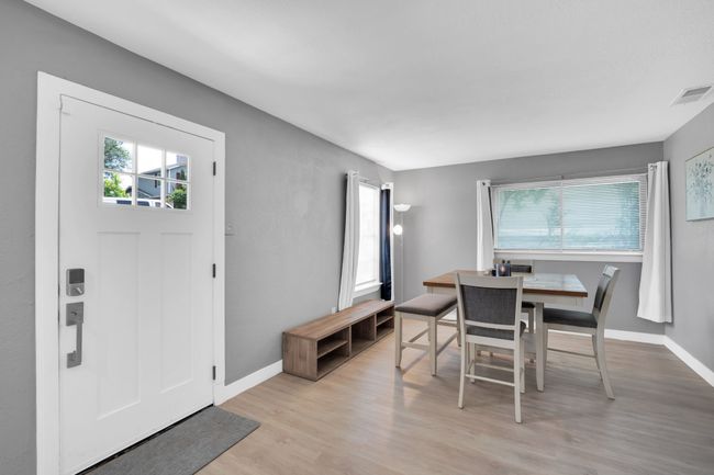 Dining area with light wood-style flooring, baseboards, a healthy amount of sunlight, and visible vents | Image 9