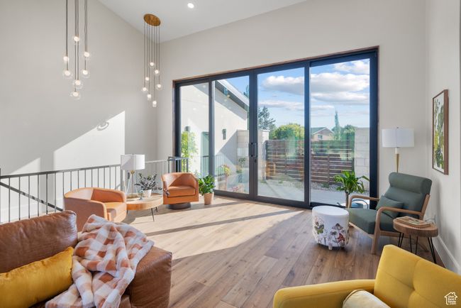 Living room featuring hardwood / wood-style floors and a towering ceiling | Image 16