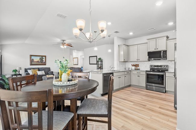 Dining area featuring ceiling fan, a chandelier, light wood-type flooring, and recessed lighting | Image 17