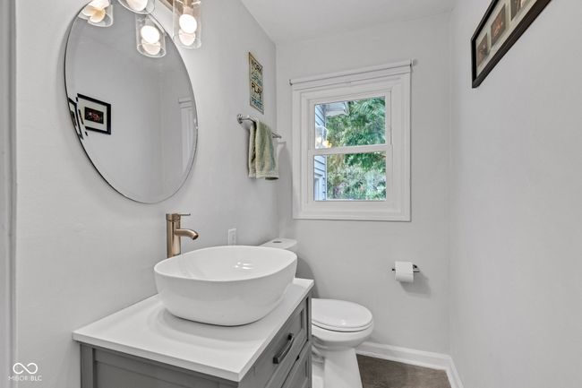 Half bathroom with vanity on main floor. | Image 21