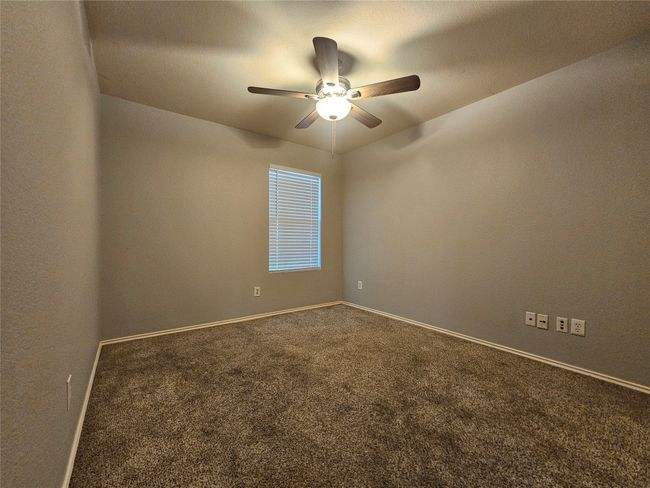 Empty room with carpet flooring and ceiling fan | Image 22