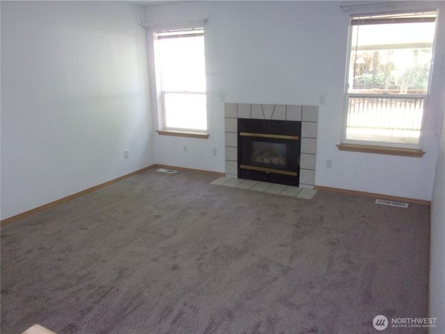 Living room features gas fireplace. | Image 9