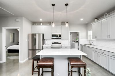 Kitchen area with island seating space | Image 3