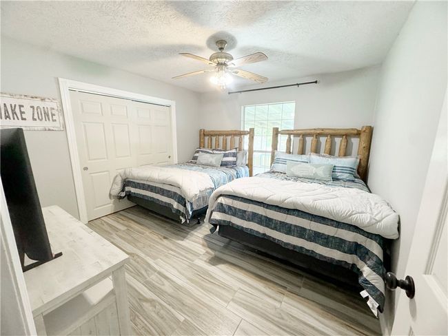 Bedroom featuring a textured ceiling, a closet, and ceiling fan | Image 10