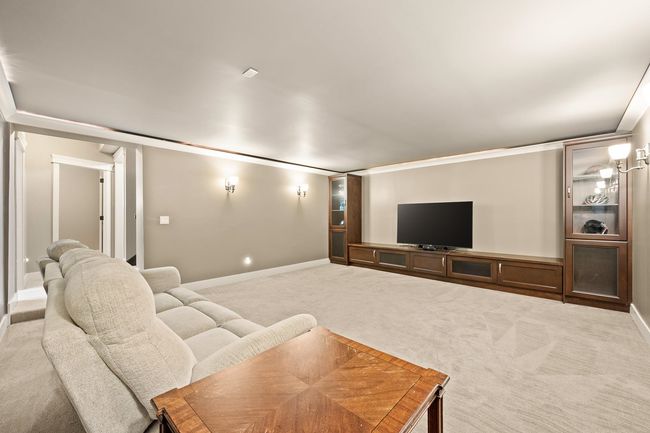 Carpeted home theater featuring baseboards and crown molding | Image 22
