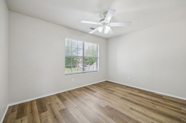 Bedroom featuring wood finished floors and ceiling fan | Image 21