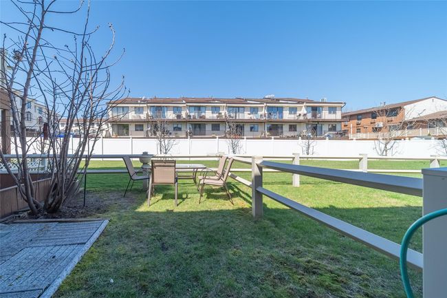 View of yard with a residential view and fence | Image 9