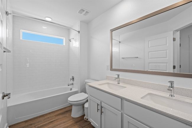 Full bathroom featuring toilet, a sink, wood finished floors, and visible vents | Image 25
