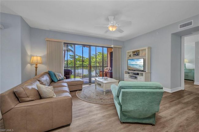 Living area with wood finished floors and a ceiling fan | Image 10