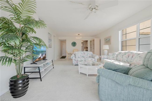 Living room with carpet and ceiling fan | Image 10