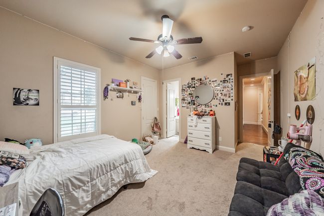 Bedroom featuring light colored carpet and a ceiling fan | Image 30