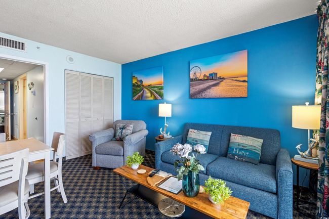 Living room with carpet flooring and a textured ceiling | Image 17