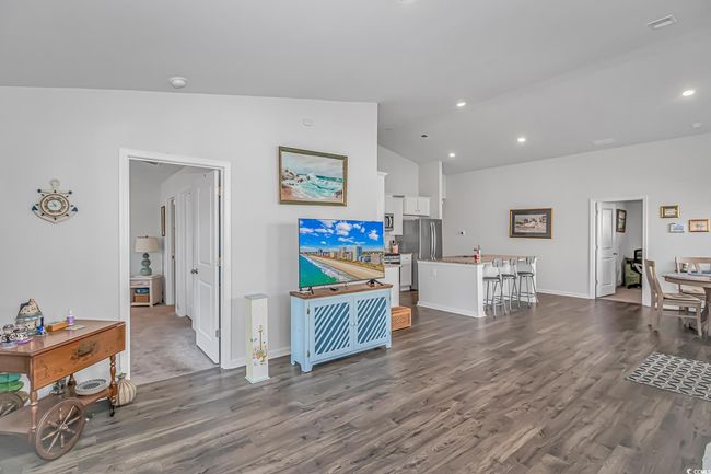 Living room featuring vaulted ceiling and dark hardwood / wood-style floors | Image 9