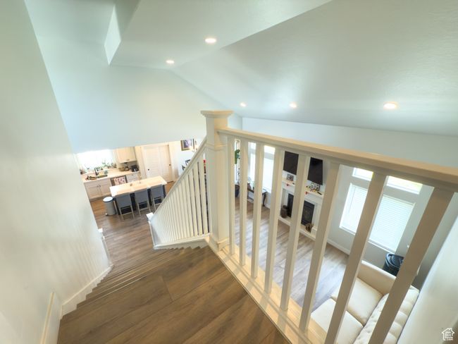 Stairway featuring vaulted ceiling, recessed lighting, and wood finished floors | Image 12