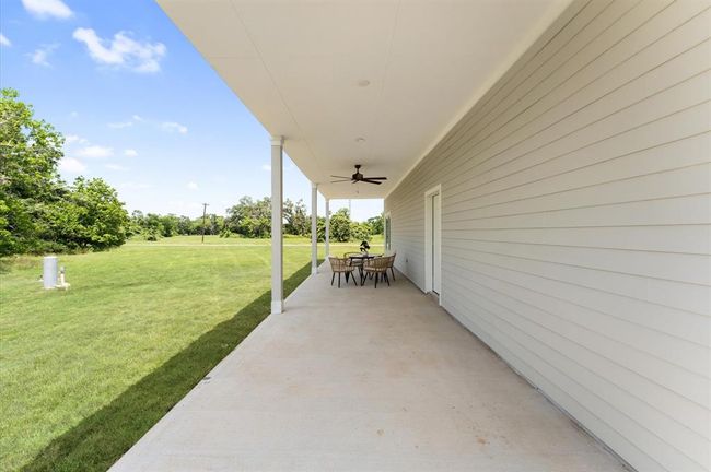 Spacious primary bedroom with direct balcony access and serene lake views. | Image 29