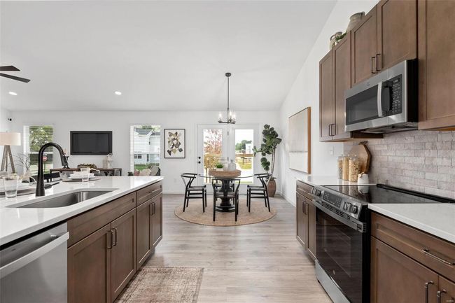 Kitchen with light hardwood / wood-style floors, stainless steel appliances, plenty of natural light, and sink | Image 8