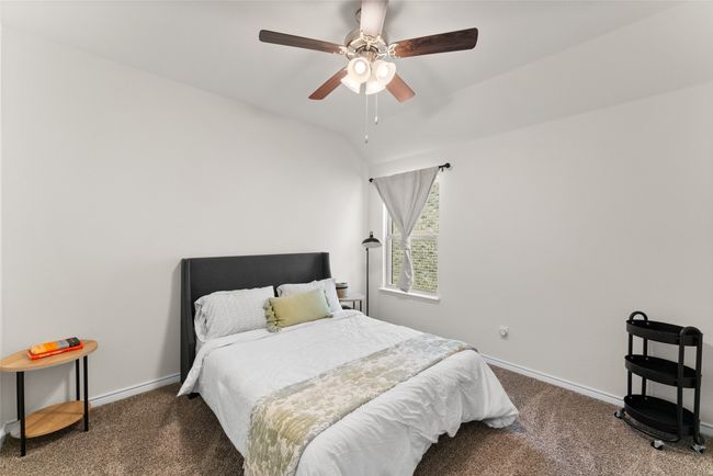 Carpeted bedroom featuring baseboards and a ceiling fan | Image 24