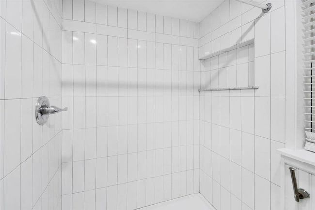 Bathroom featuring a tile shower | Image 14
