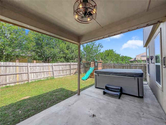Fenced backyard with a hot tub, a patio, and a playground | Image 27