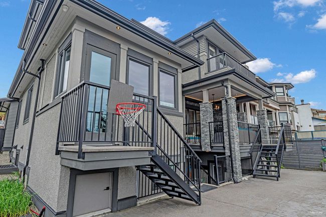 View of side of home featuring a porch, stairs, and stucco siding | Image 7