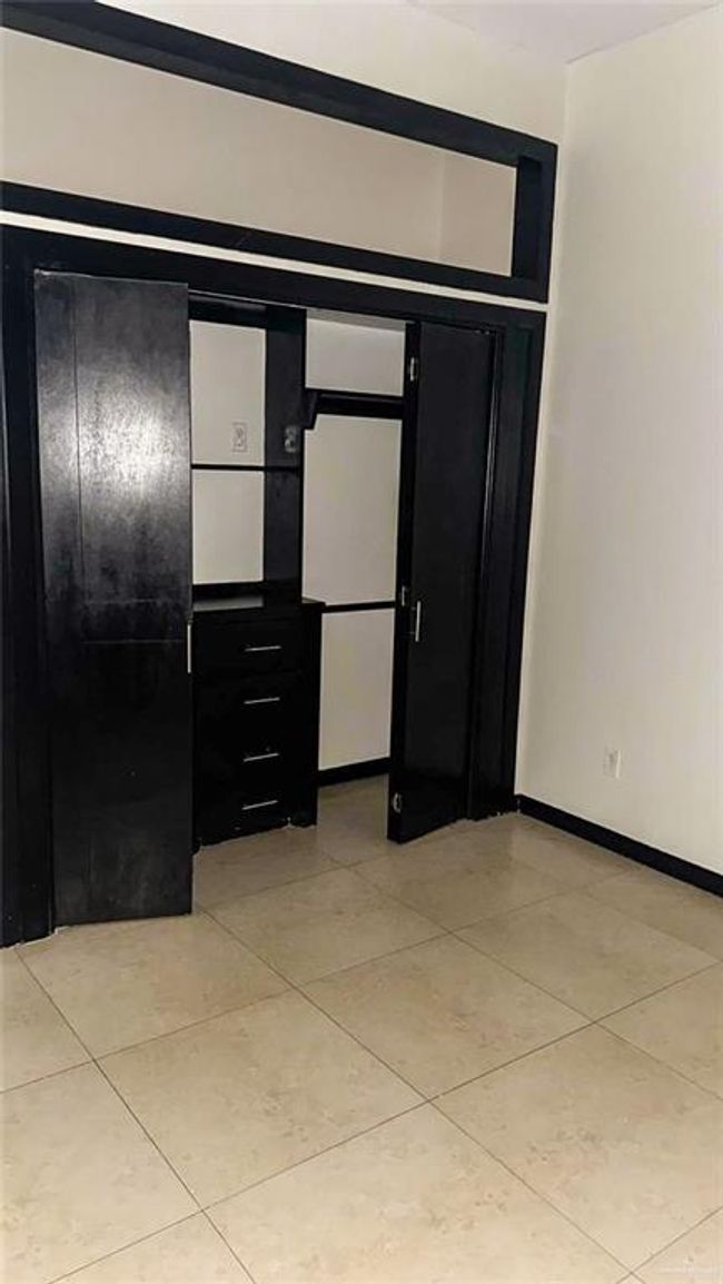 Spacious closet for third bedroom with built ins. | Image 14